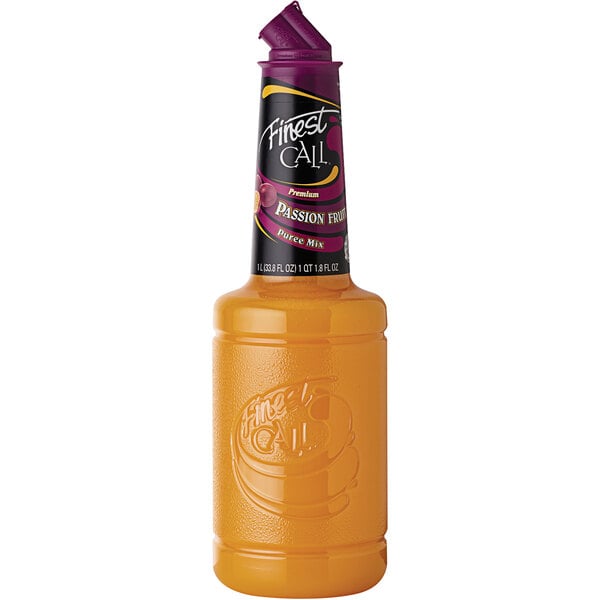 A close up of a bottle of orange liquid with a purple lid.
