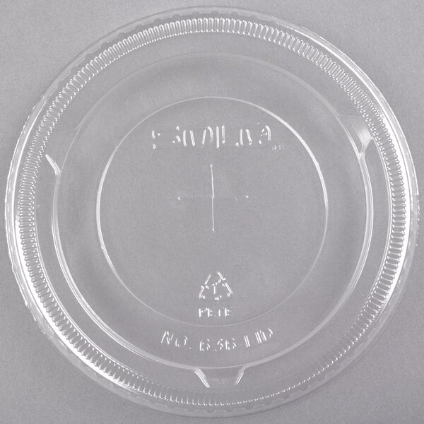 A clear plastic Solo lid with a straw slot on a clear plastic container.