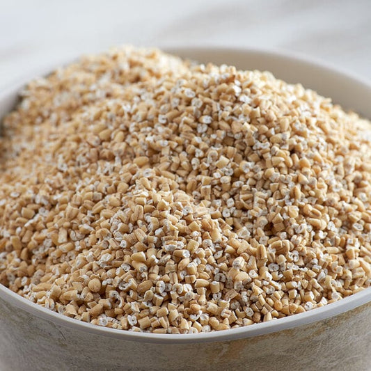 A bowl of Bob's Red Mill steel cut oats on a table.