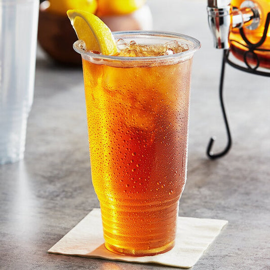 A clear Choice HD plastic cup of iced tea with a lemon wedge.