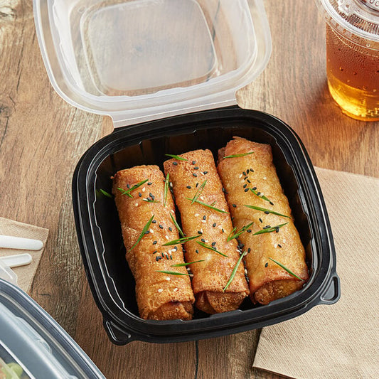 A Choice plastic container of food with a lid and a drink.