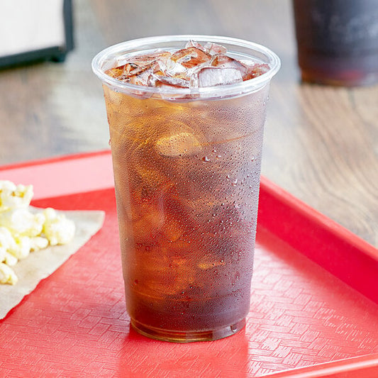 A Choice clear plastic cup with ice and a drink on a red tray.