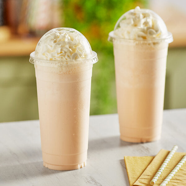 Two Choice clear PET plastic cups with milkshakes and whipped cream on top with straws.