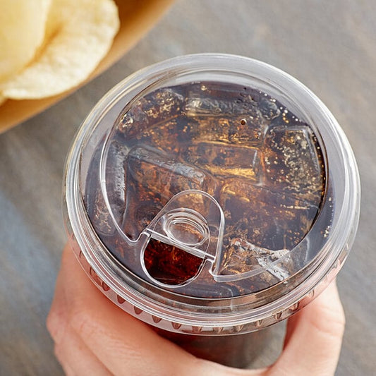 A hand holding a Choice clear plastic cup with a brown liquid and a strawless/sip lid.