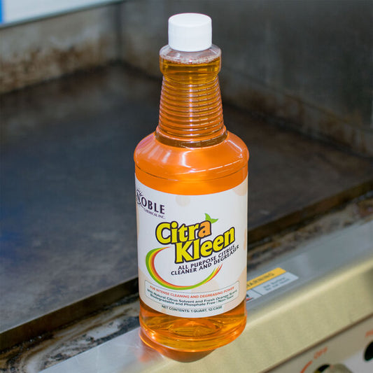 A bottle of Noble Chemical CitraKleen liquid citrus cleaner on a counter.